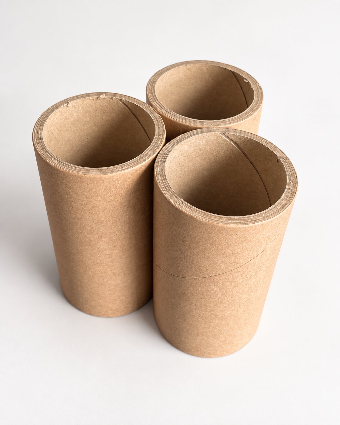 Drei Papphülsen im Format 55 × 65 × 124 mm, schräg von oben